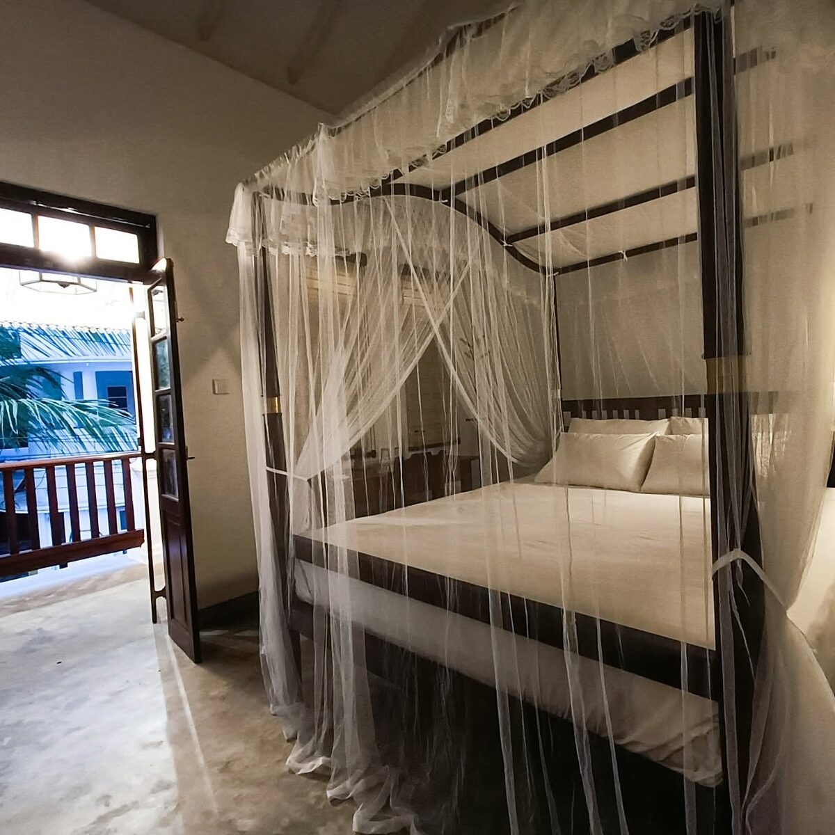 Upstairs Verandah Room — canopy bed and balcony doors