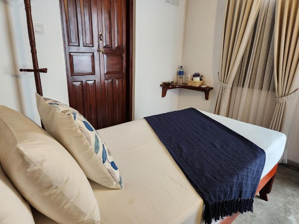 Downstairs Arch Room — bed with indigo throw