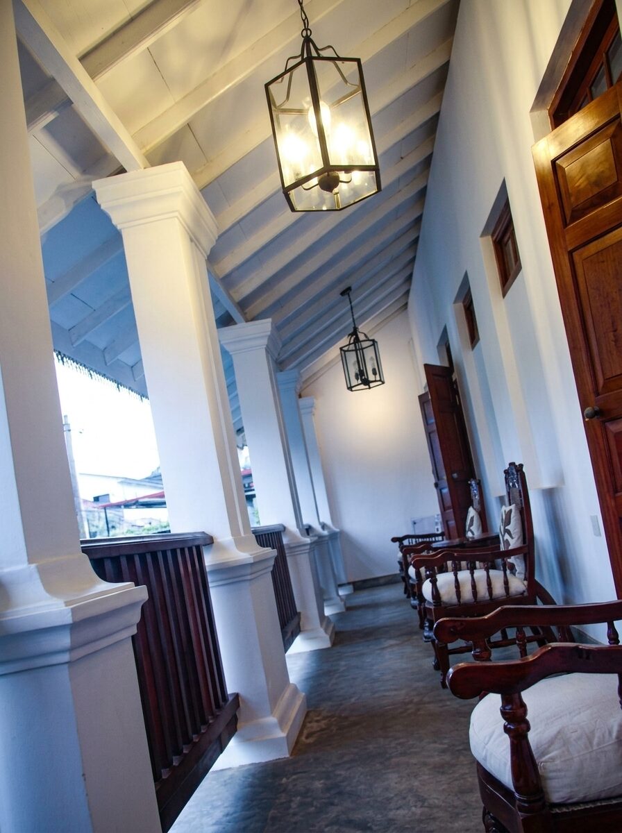 The upper verandah with lanterns and teak chairs