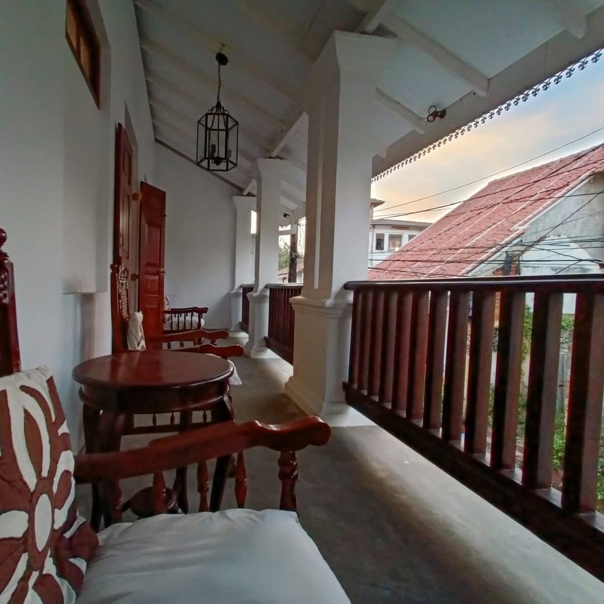 Verandah at sunset over terracotta roofs